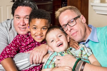 Gay parents and their children pose for a photo