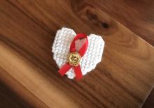 AIDS Awareness Ribbon and Pin of Remembrance. Credit: NIAID